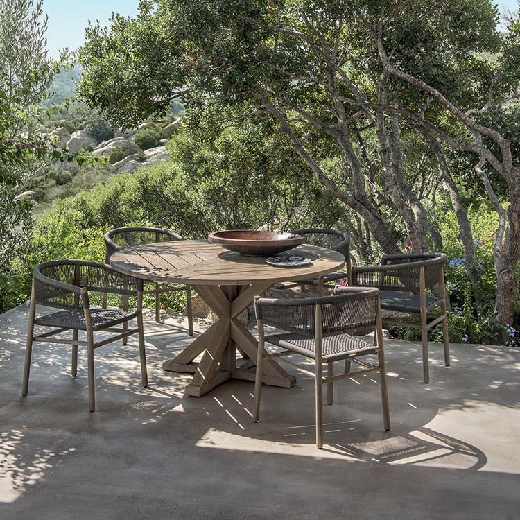 Circular Teak Outdoor Dining Table Set in a Lush Garden | High-End Outdoor Dining Furniture | Luxury Teak Table with Rope Chairs | Designed and Made in Italy | Ethimo Cronos