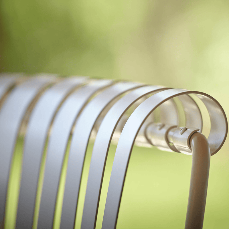 Close-up of the curved backrest of the Elegant Iron Patio Armchair, showcasing its refined metal design. | Luxury Metal Garden Furniture | Designed and Made in Italy