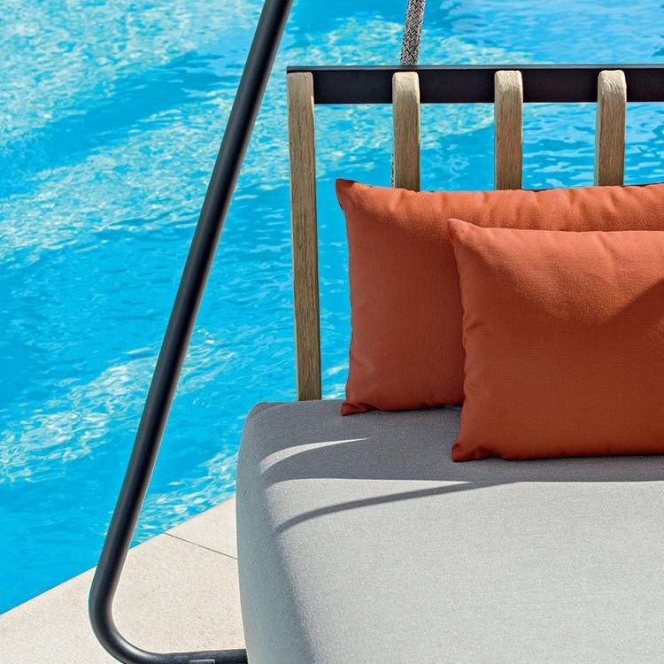 Close-up of the teak and aluminium backrest with decorative cushions on a luxury outdoor sofa swing | High-End Outdoor Furniture | Designed and Made in Italy | Ethimo Swing