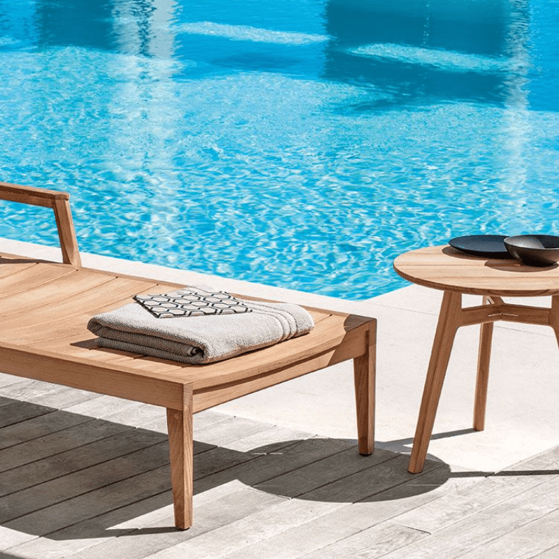 Circular Outdoor Teak Coffee Table by the Poolside | Luxury Garden Furniture | High-End Teak Table for Relaxation.